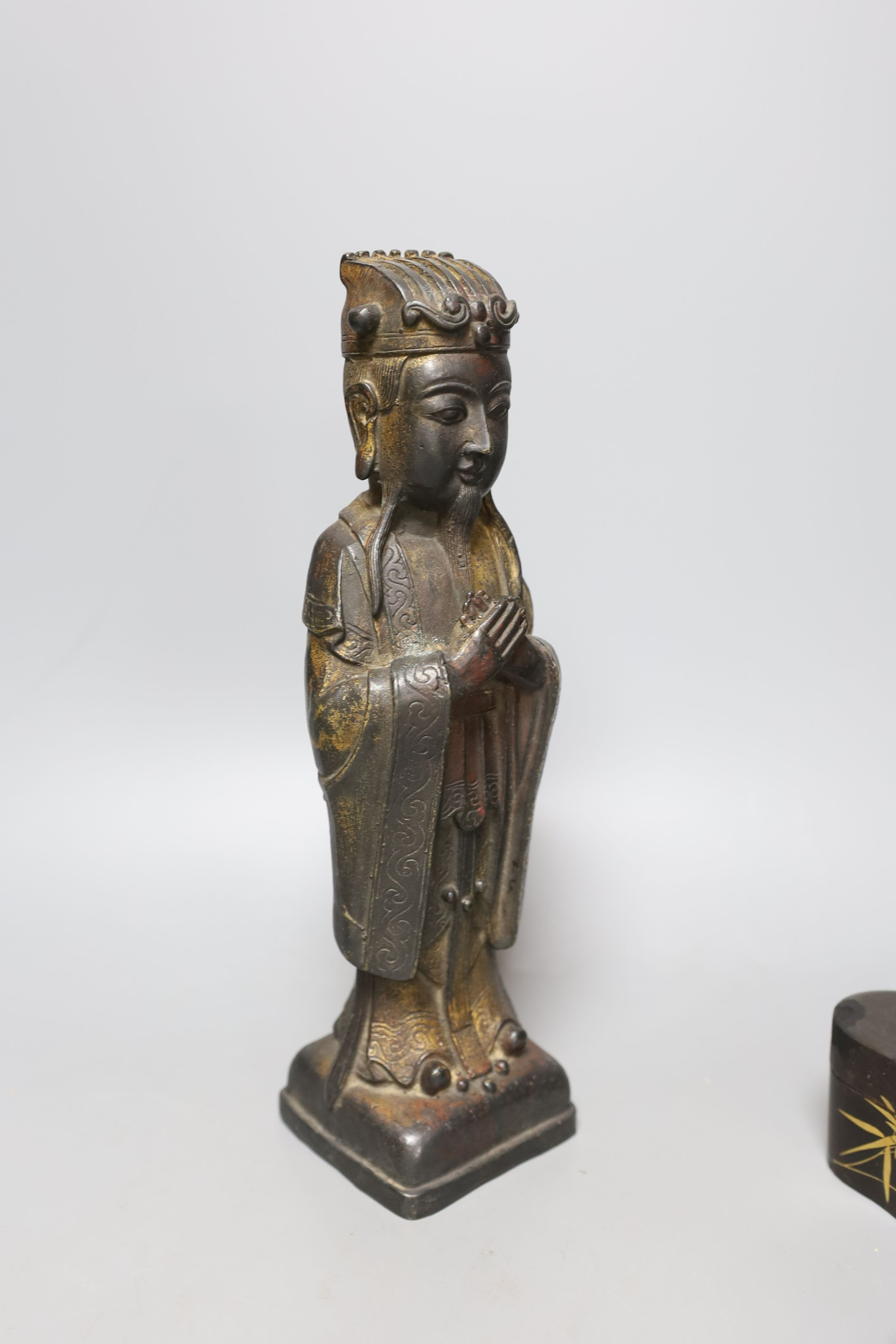 A Chinese bronze figure of an official and three Japanese lacquer boxes. Tallest 29cm